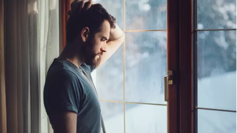 Man staring out of window