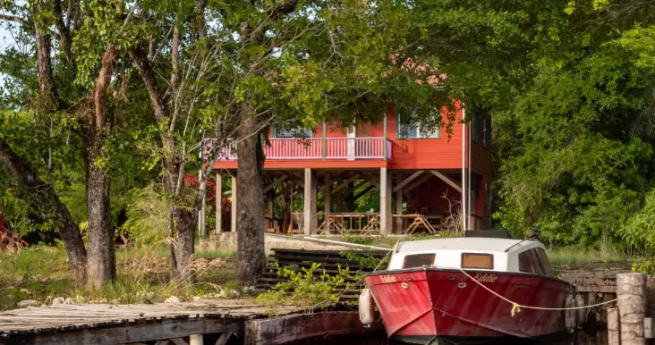 A red and white boat tied up