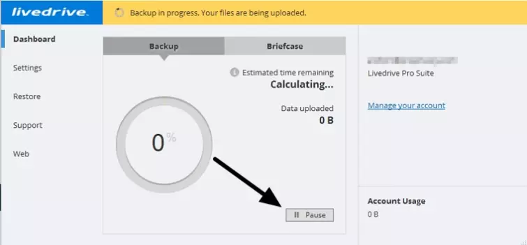an arrow pointing to the pause backup button