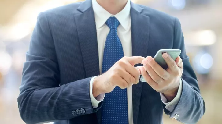Men in suit using a mobile phone