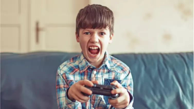 young boy with a game controller 