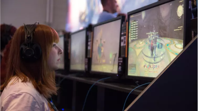 girl playing mmo games with head phones on 