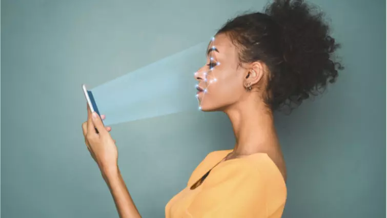 women looking at her phone that is using facial recognition