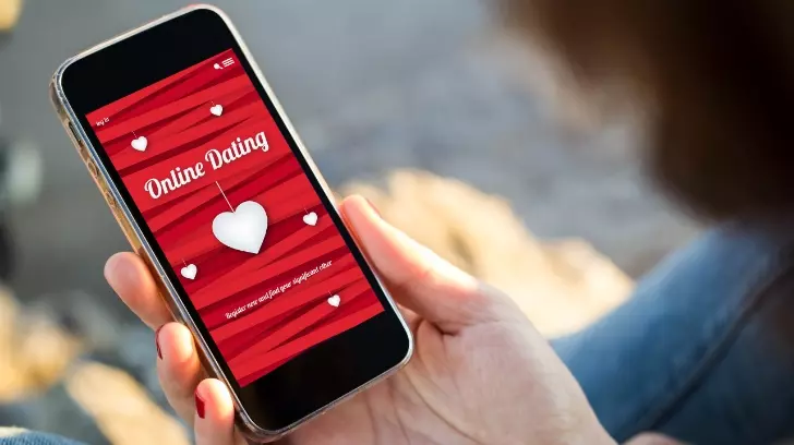 Mobile phone with mobile dating written on the laptop